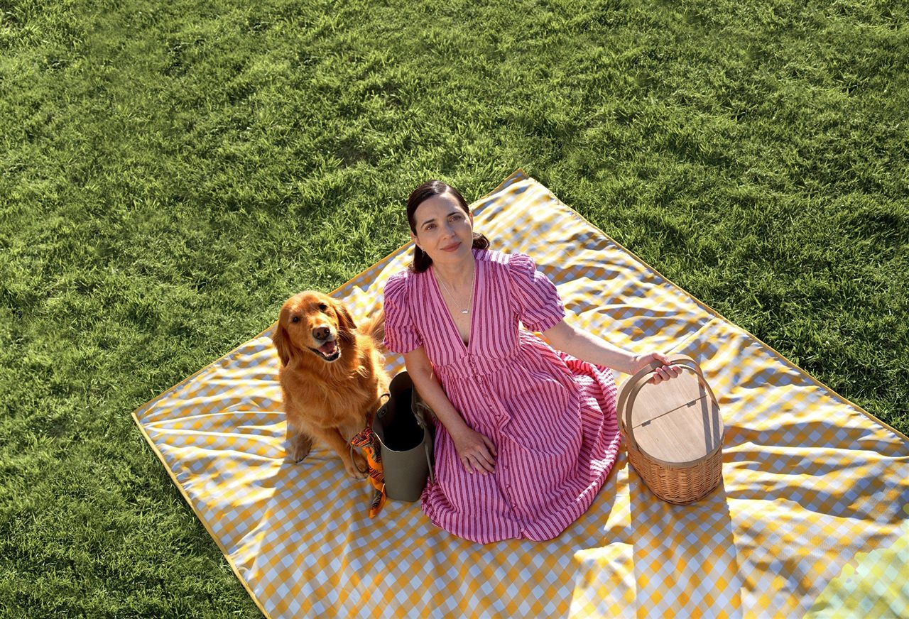 Ariel view of woman and her dog on a picnic with a basket and blanket. Learn more about asthma at asthma.com.