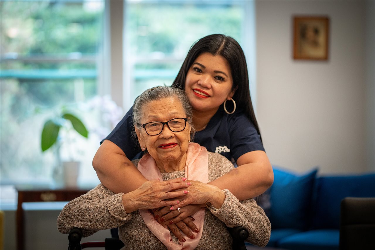 Strela's grandmother and a caregiver from Vivid Life Home Care.