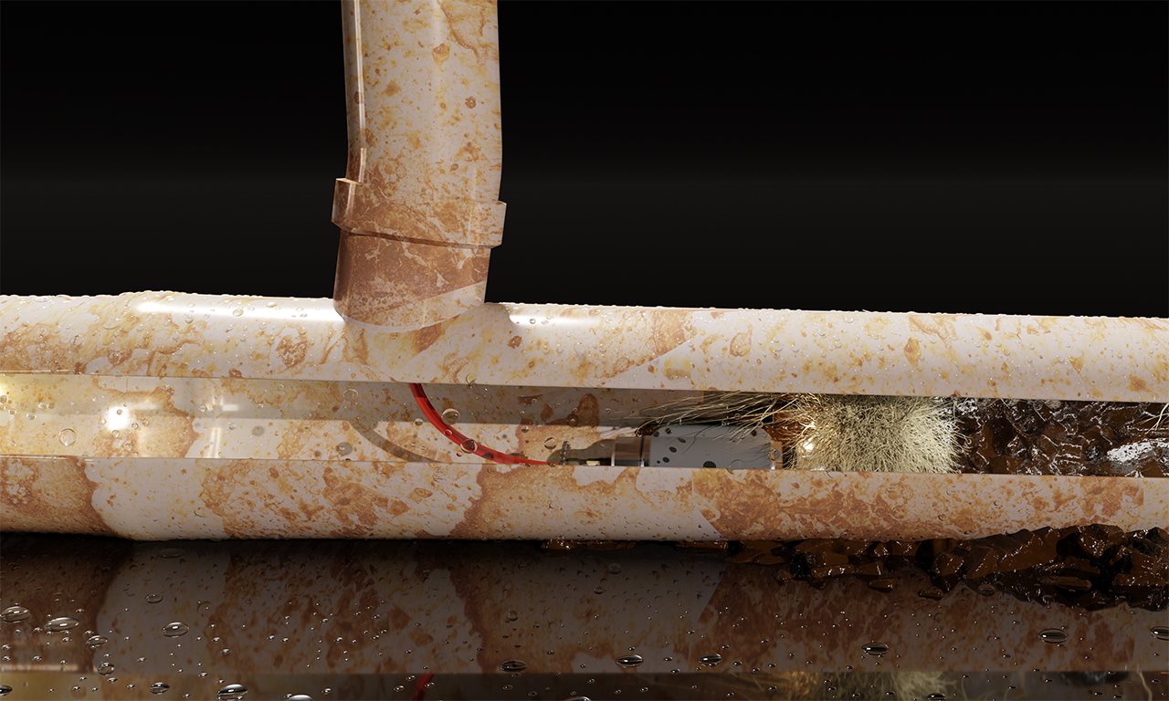 Close up of a PVC tube with a device used to clear away roots