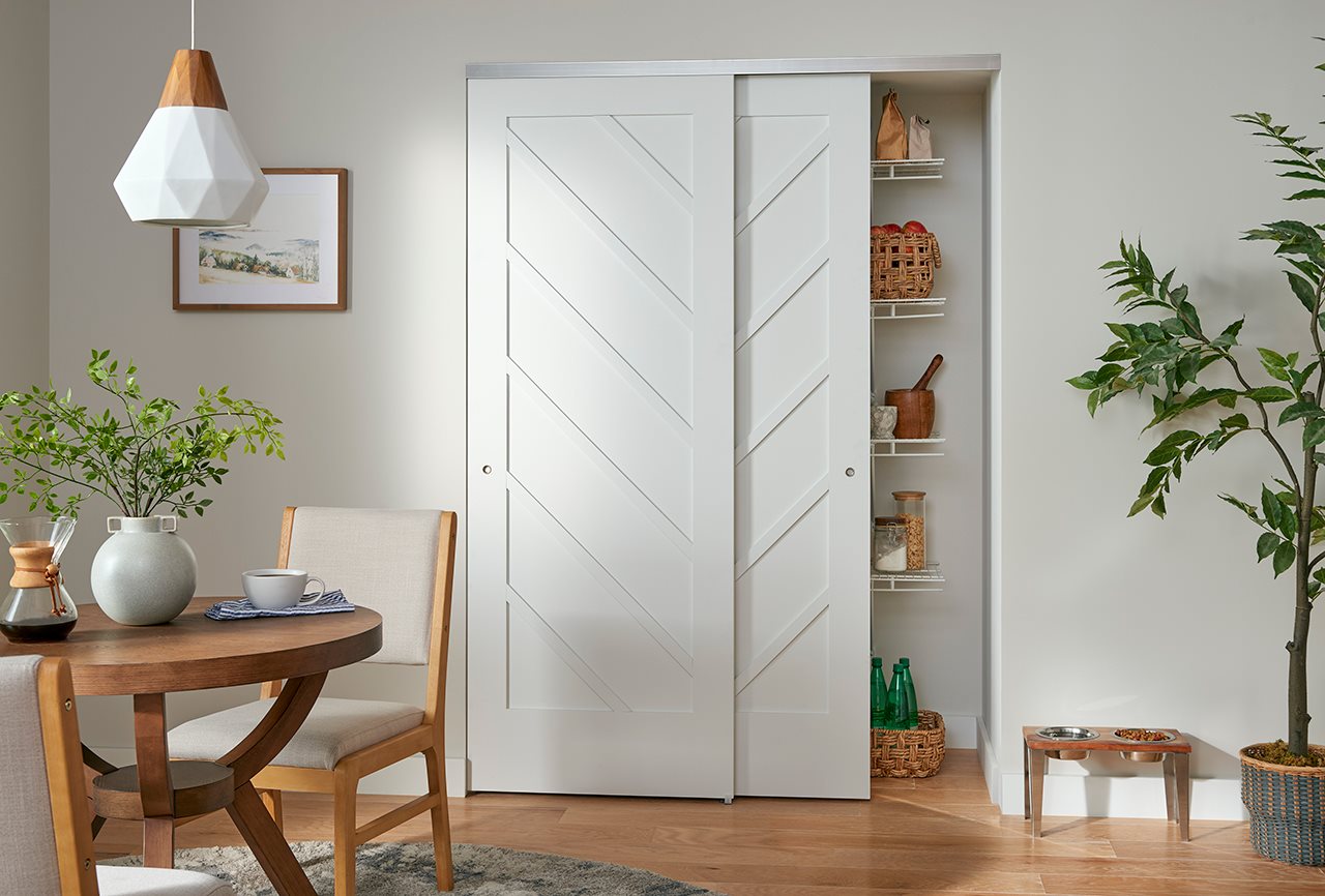 Double pocket door hiding pantry in kitchen
