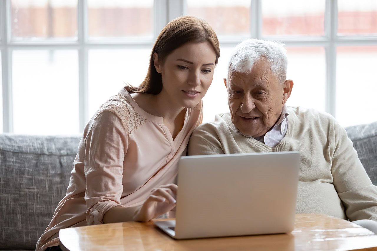 Granddaughter help grandfather protect himself from cyber attack on his laptop computer