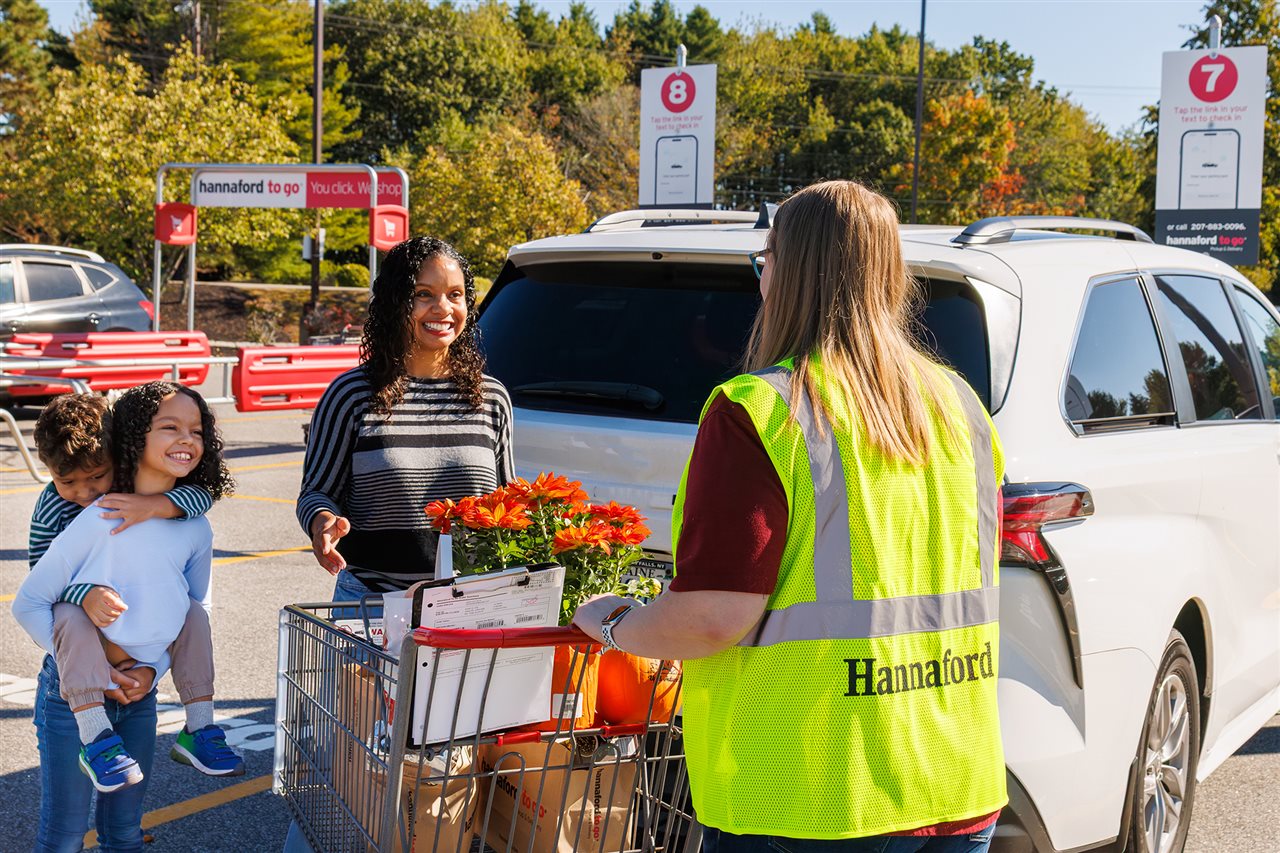 A Family loads their vehicle with foods purchased at Hannaford Supermarket.