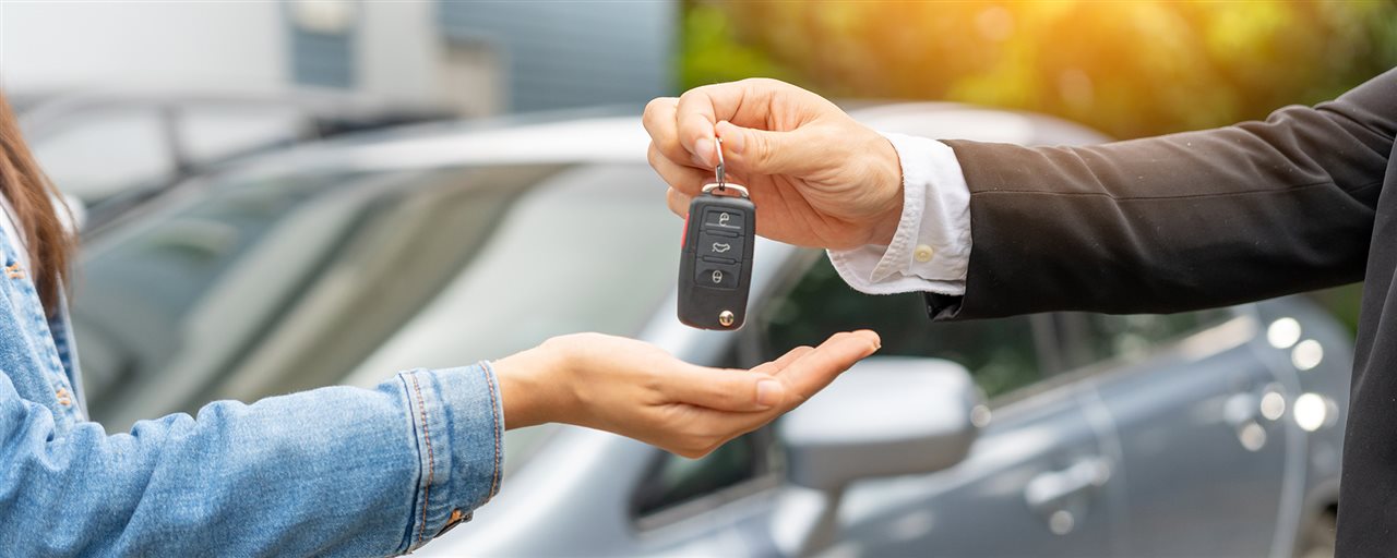 Car keys given from one person to another. Flexcar allows vehicle return at any time without early termination penalties.