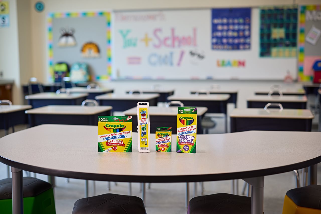 Family of Crayola products on a desk in a classroom