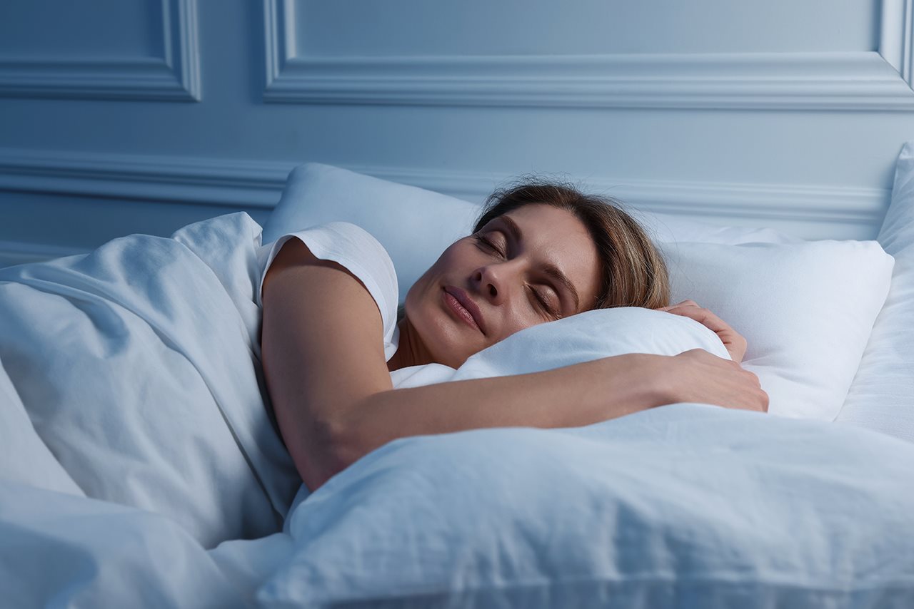 Woman plesantly sleeping in bed