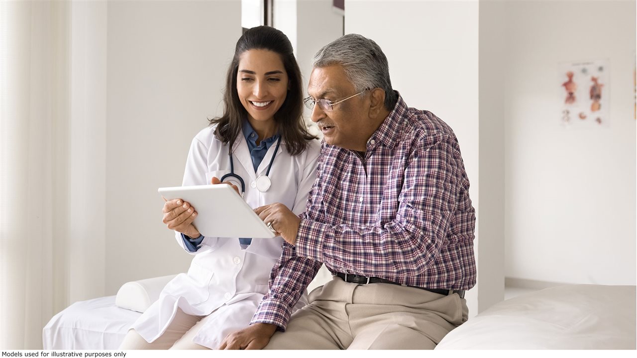 A Physicians Associate, a member of an organzation like the American Academy of Physicians Associates (AAPA), intaking information about a patient's condition in an exam room.