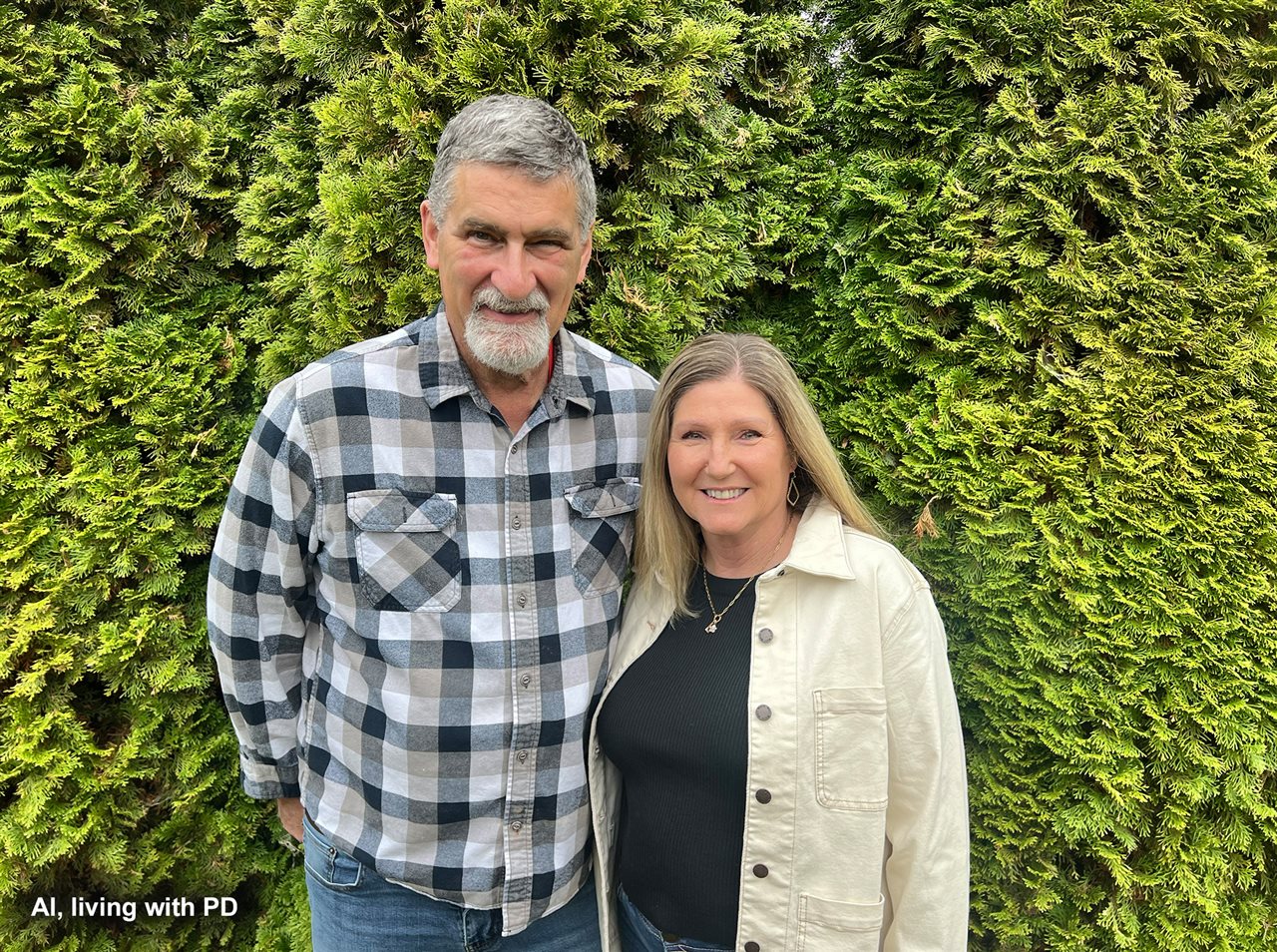 Al and Lisa with greenery behind them