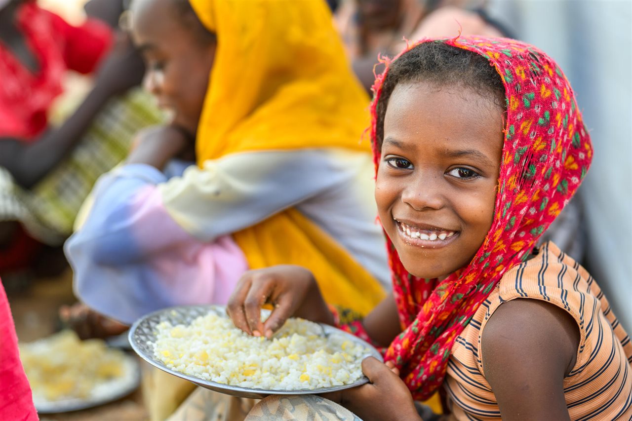 Sudanese refugee children at a World Vision school feeding program in Farchana Refugee Camp, Chad.