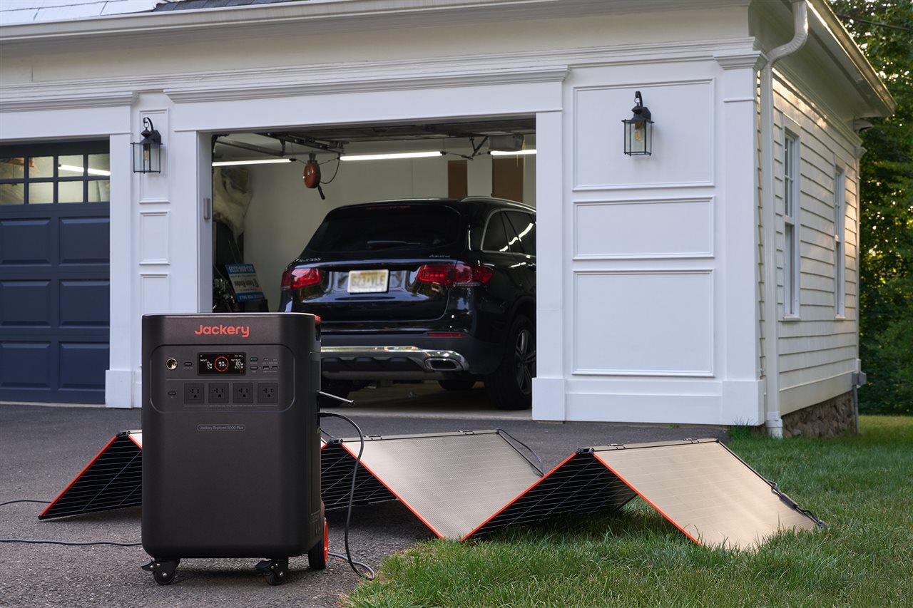 Jackery solar powered generator charging up on the driveway in the front yard.