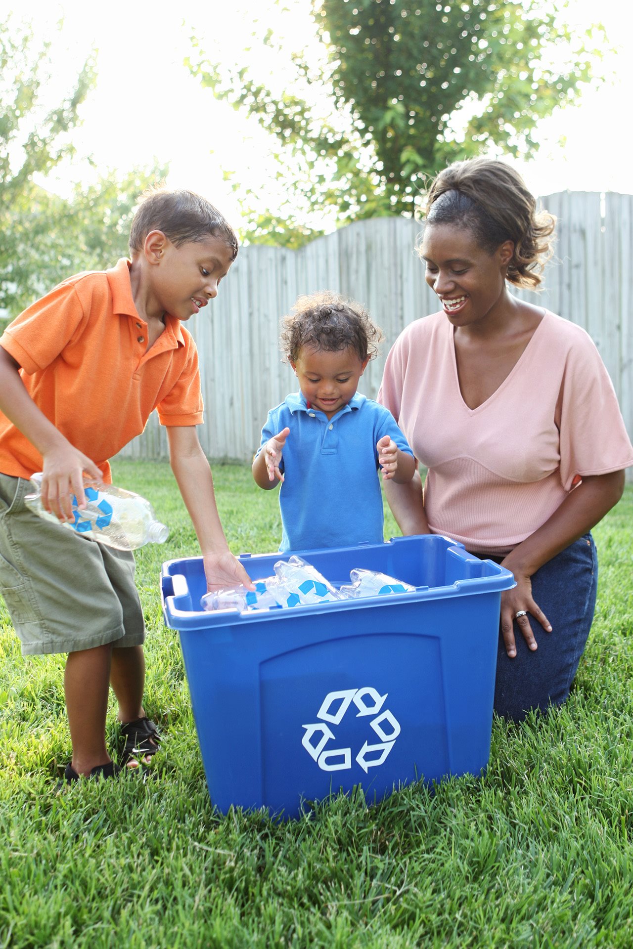Woman and her children gathering recycled bottles