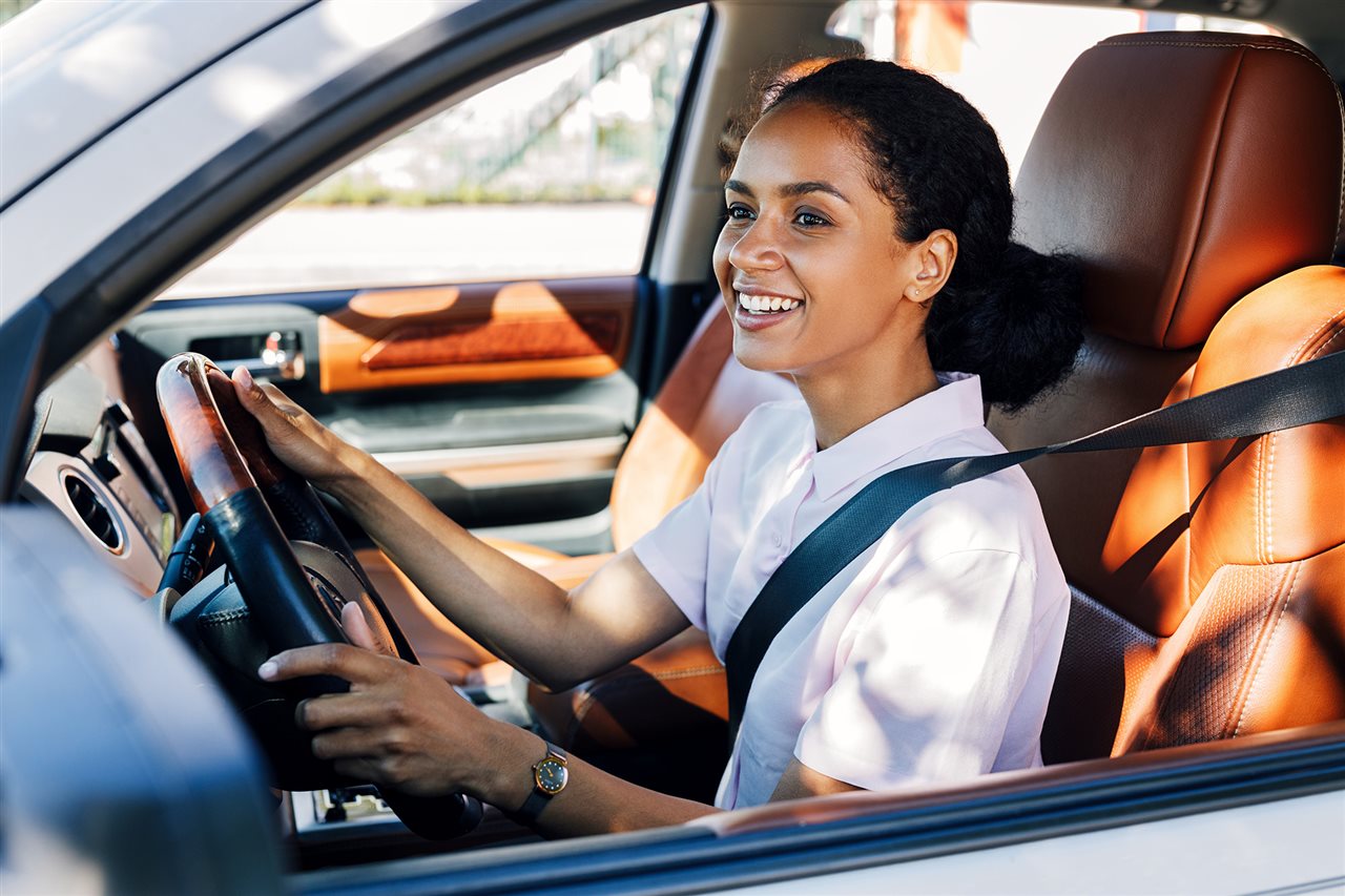 Happy woman driving car. Flexcar aims to make having a car more flexible.