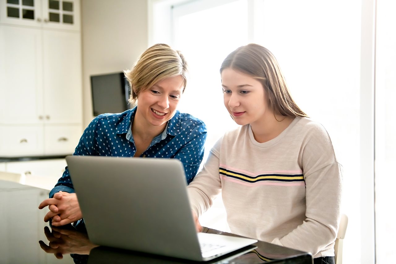 Mom and Daughter looking for student loans online