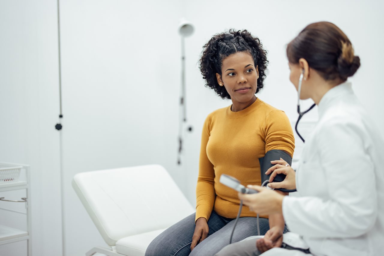 Woman talking with her doctor. The Symplicity Spyral renal denervation system is indicated to reduce blood pressure as an adjunctive treatment in patients with hypertension for whom lifestyle modifications and antihypertensive medications do not adequately control blood pressure.