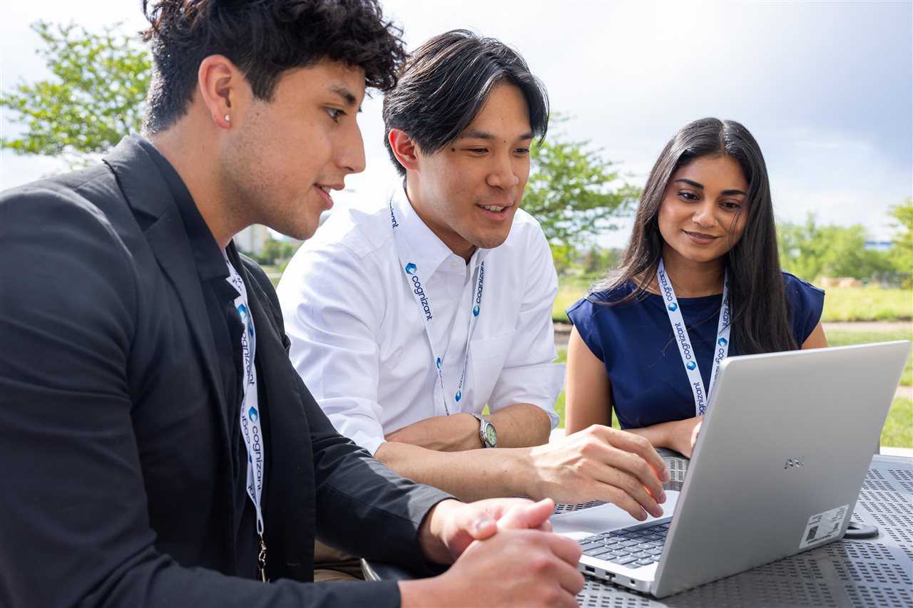 Woman from Cognizant taking with two interns.