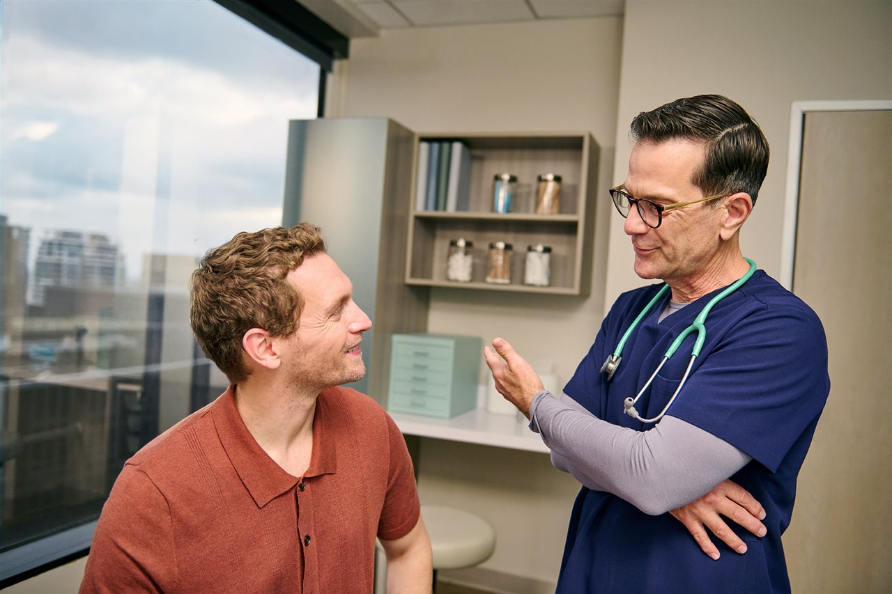 Doctor talking with young man. One Medical has offices in Raleigh, North Carolina.
