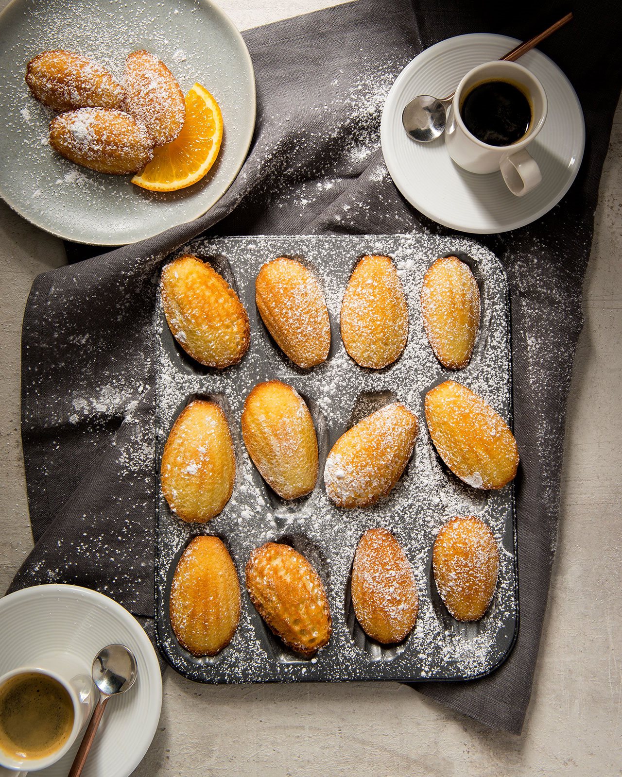 Lemon and Olive Oil Madelaine's sprinkled with powdered sugar.