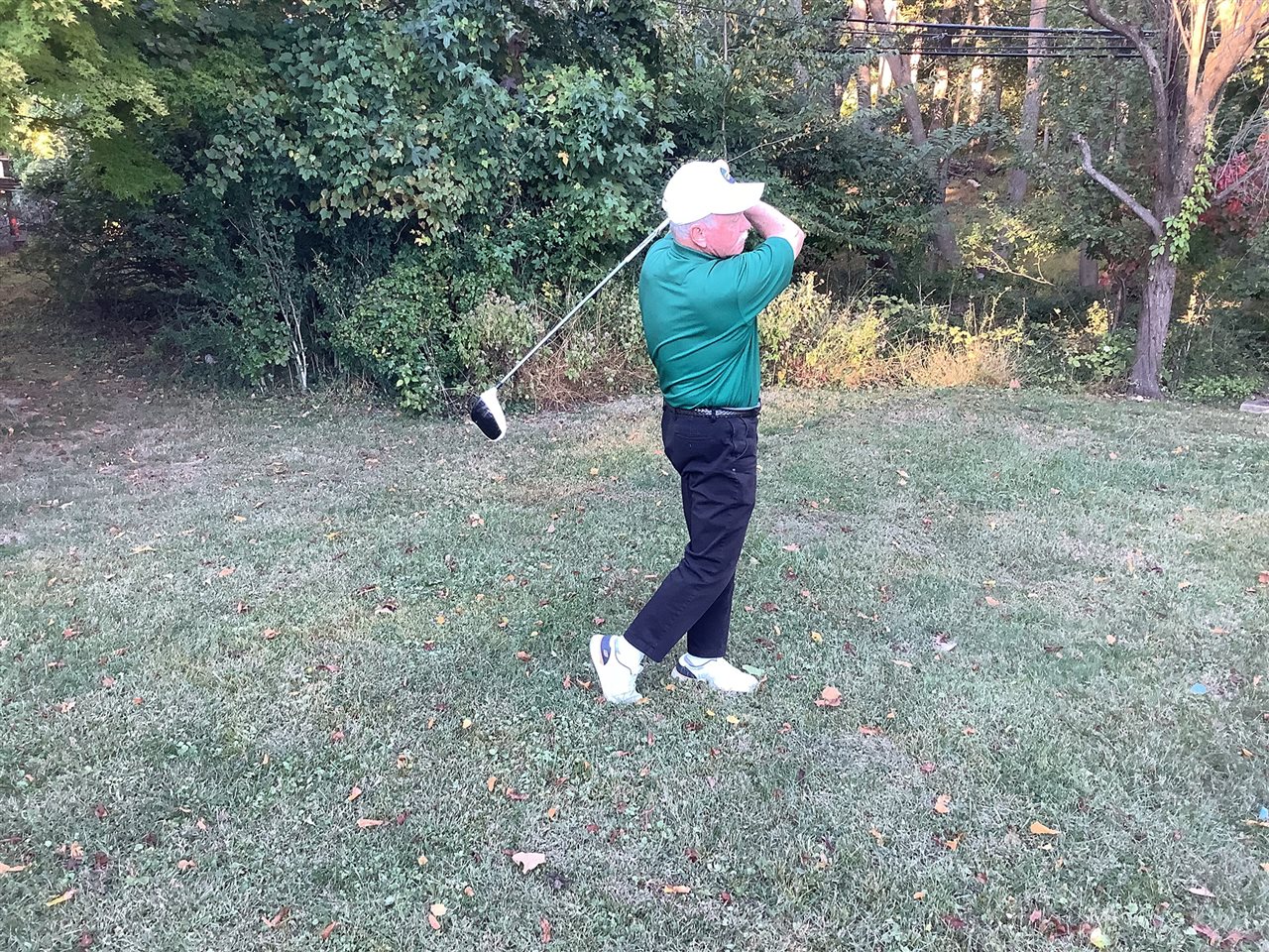 Jim swinging a glof club on the course.