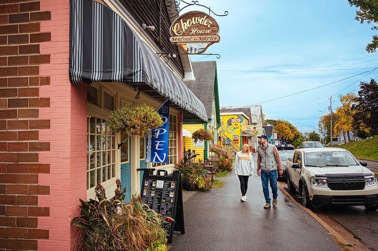 Couple walking past a charming shop in Tatamagouche