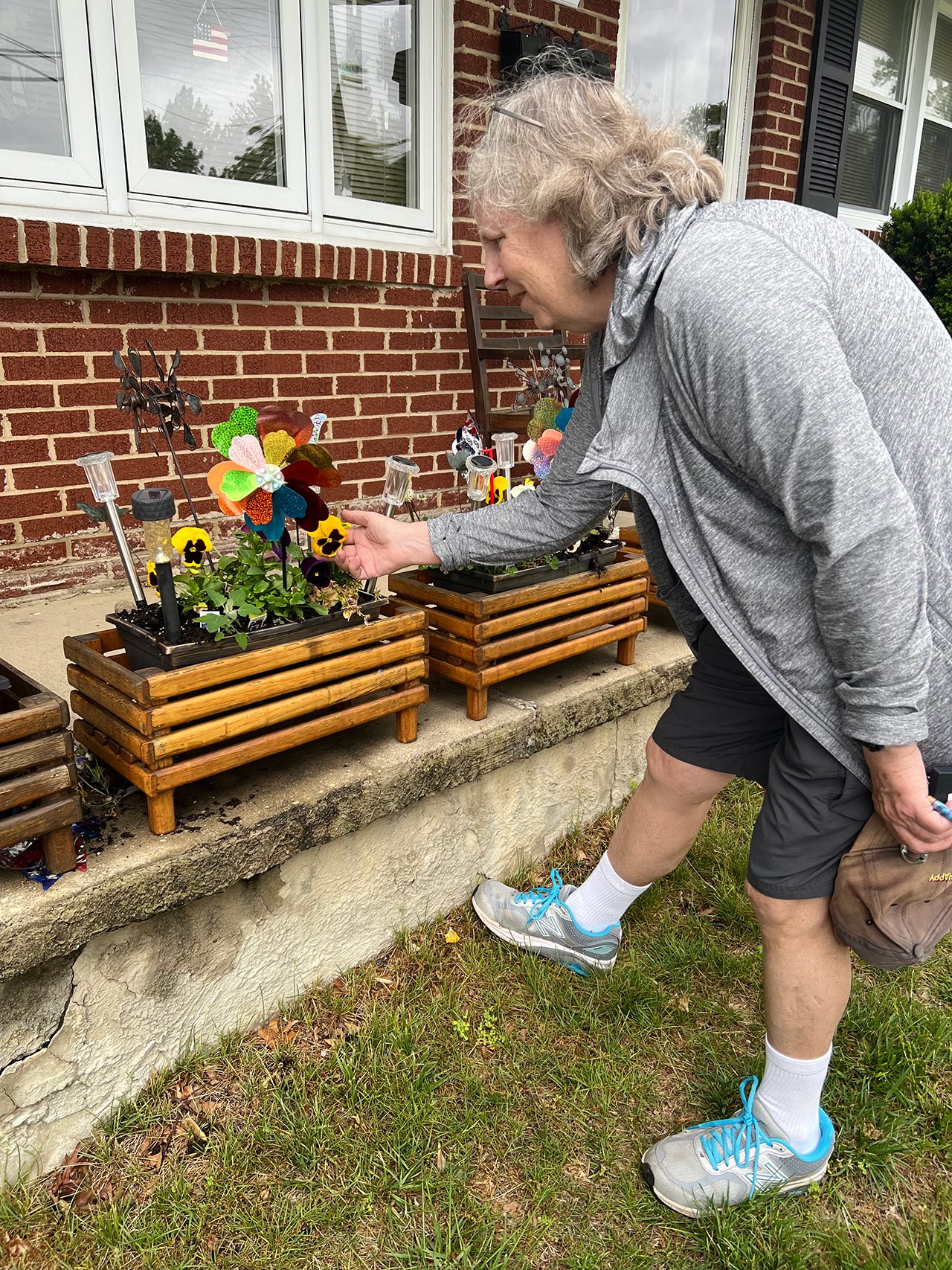 Ann looking at a planter of flowers