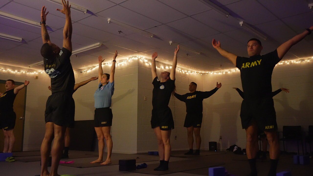 Soldiers of the U.S. Army exercising in a gym.