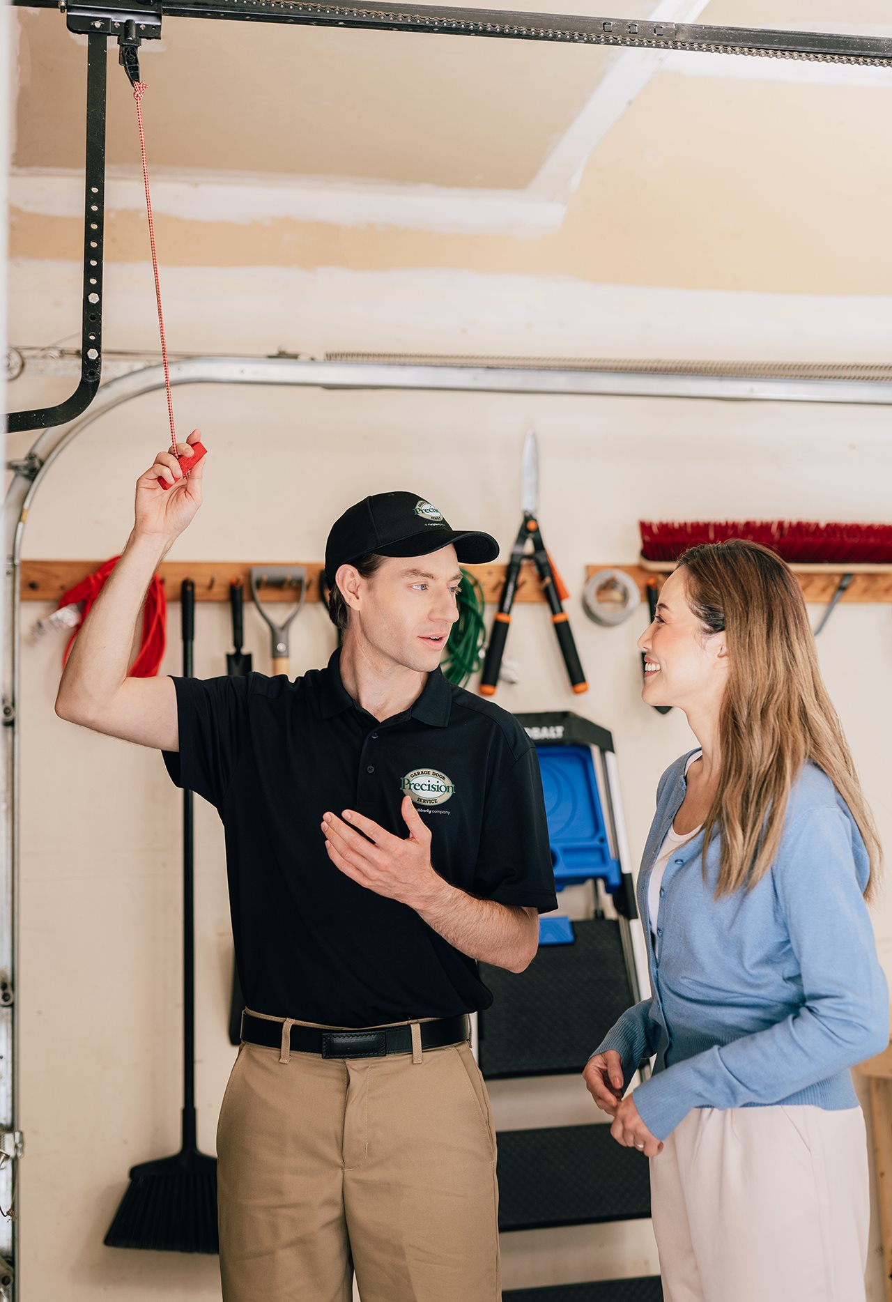 Representative from Precision garage door inside the garage showing the home owner how to disengage the garage door opener.