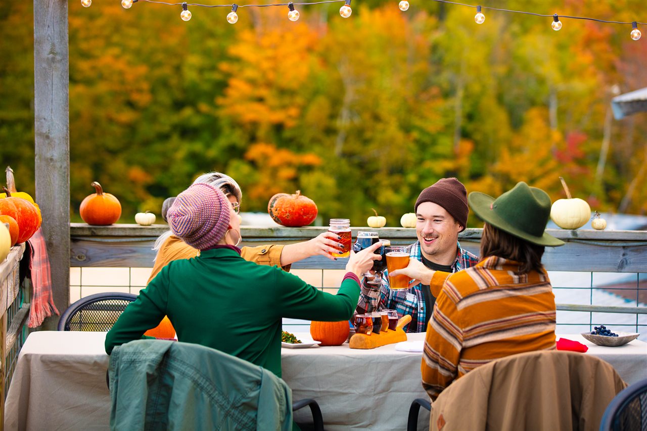 Friends toasting each other while enjoying a Fall day outside