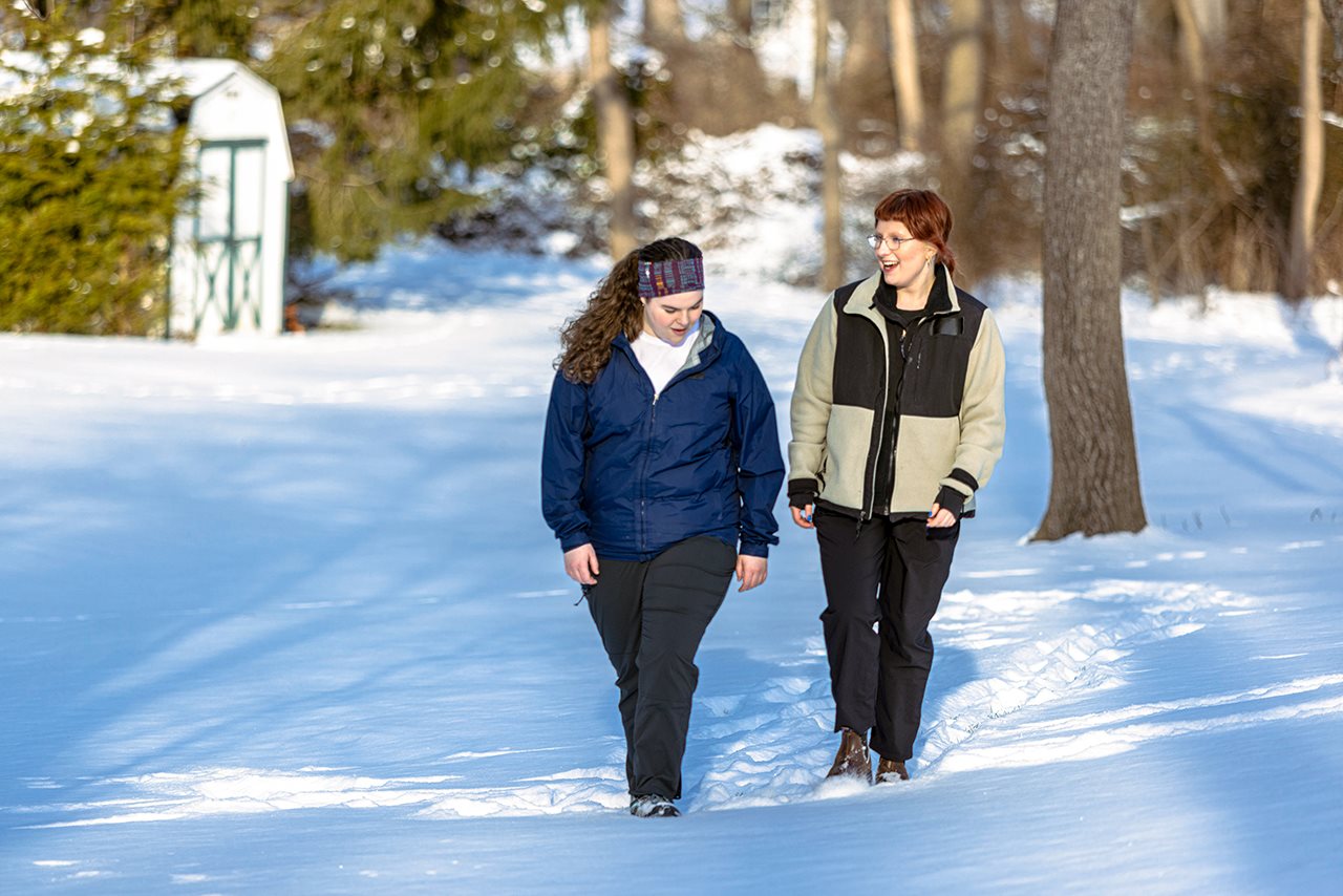 Two woman walking in the snow.