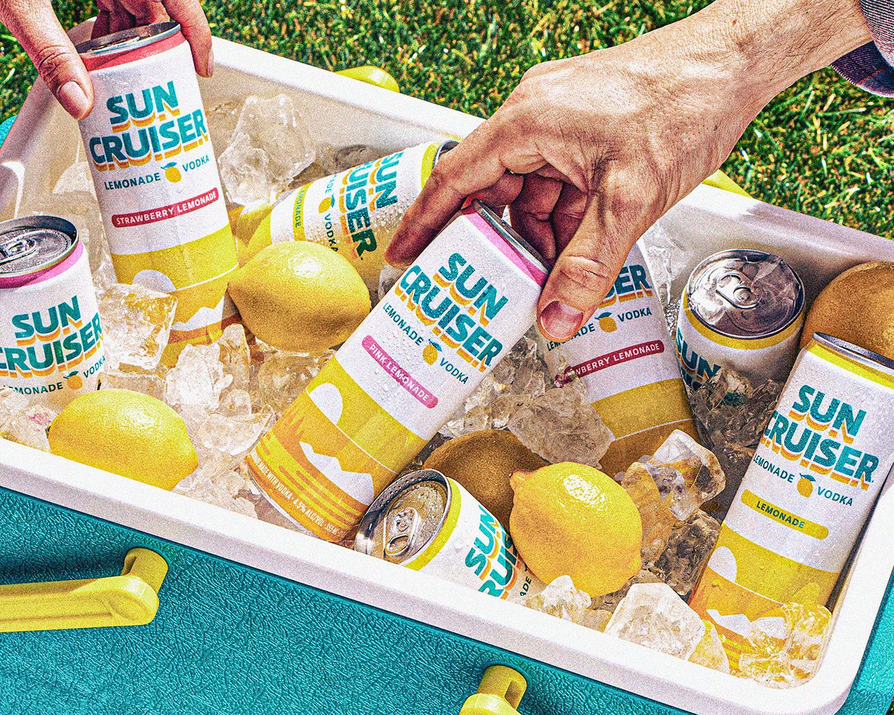 People taking a cold Sun Cruiser out of a cooler filled with ice.