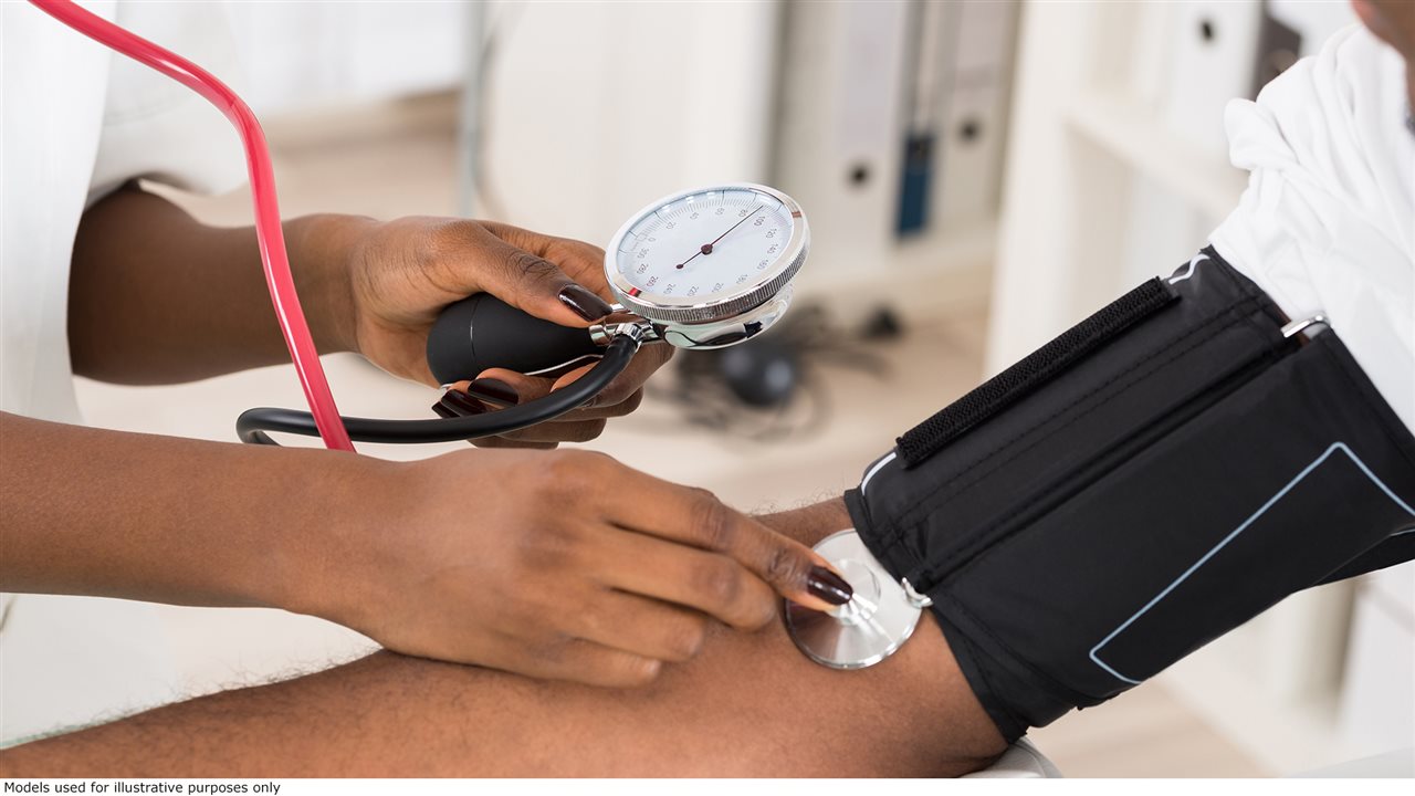 Man having his blood pressure taken by a health care provider. High blood pressure is a chronic condition often referred to as the 