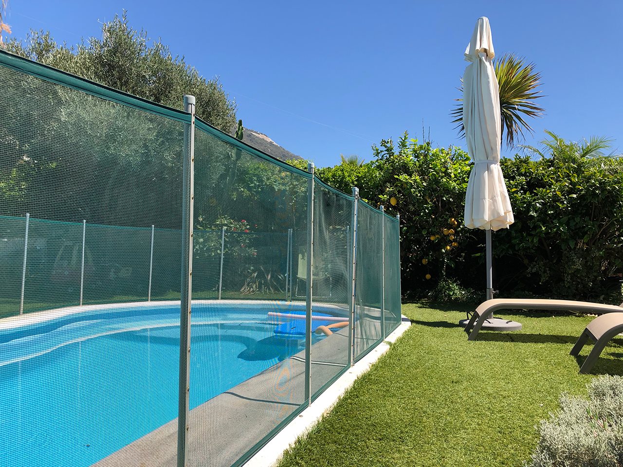 Swimming pool with protective fencing.