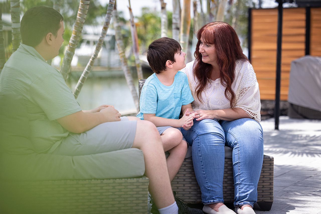 Rosetta talking with family while sitting in the backyard