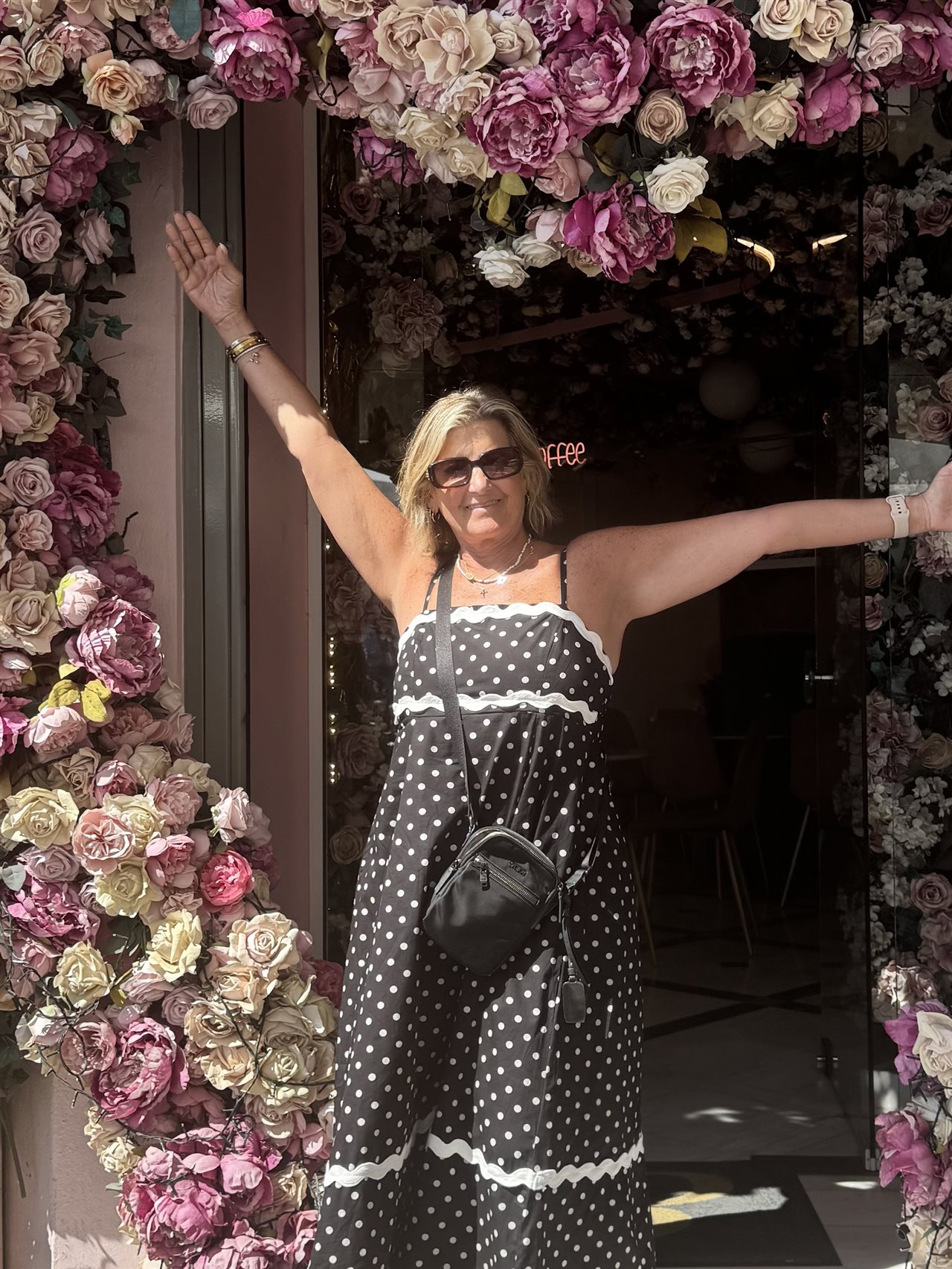 Marin wearing a sundress in front of a floral shop.
