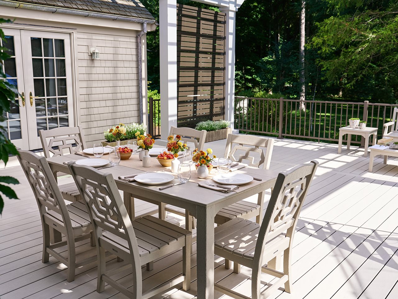 A furnished outdoor dining table on a patio.