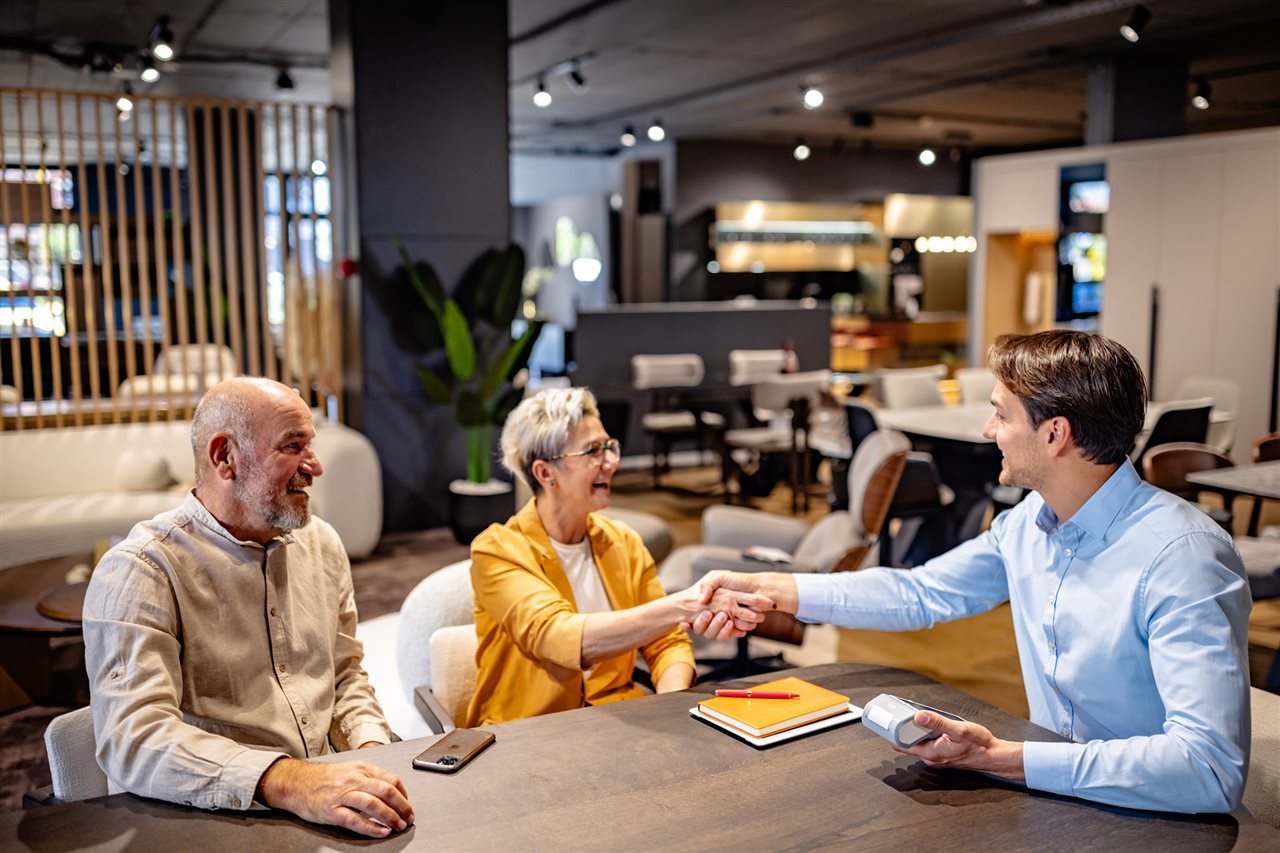 Business owner uses cell phone. Synchrony helps businesses with digital tools, training and financing infrastructure.