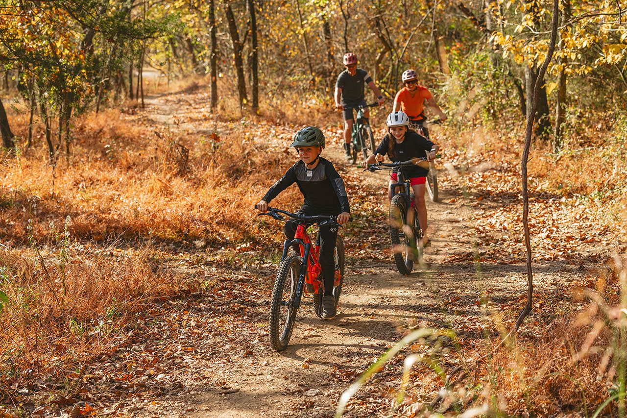 Happy family biking on a park path in Bentonville