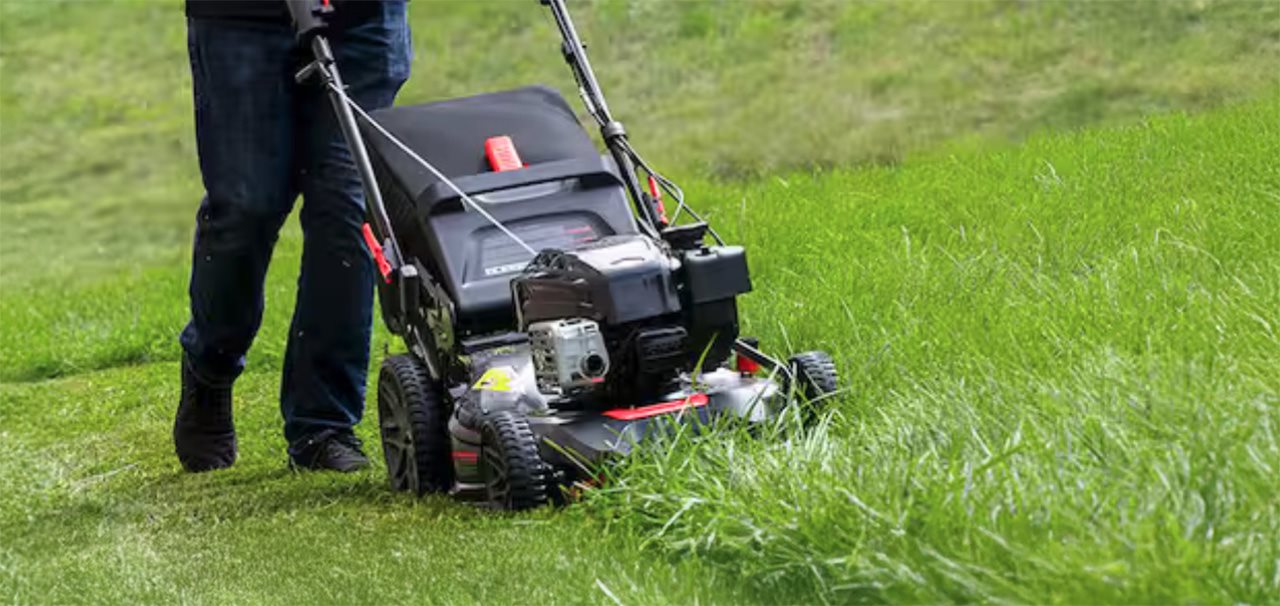 Person running lawn mower in the tall grass. Briggs and Straton mowers have powerful, sustained torque for thick grass.