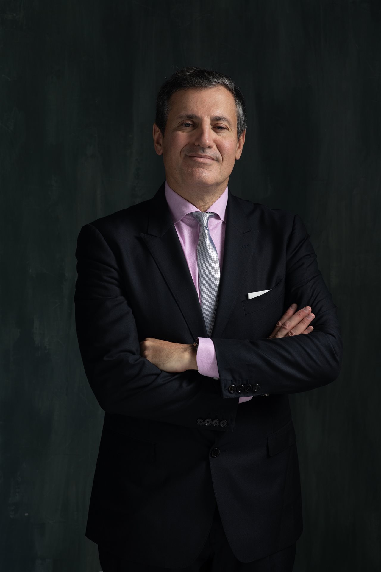 Dr. Norman Rowe wearing a suit and tie. Rowe Plastic Surgery specializes in a full range of surgical procedures.