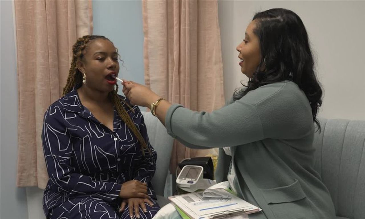 Doctor giving her patient the GeneSight Test from Myriad Genetics. This cheek swab may indicate medications to use.