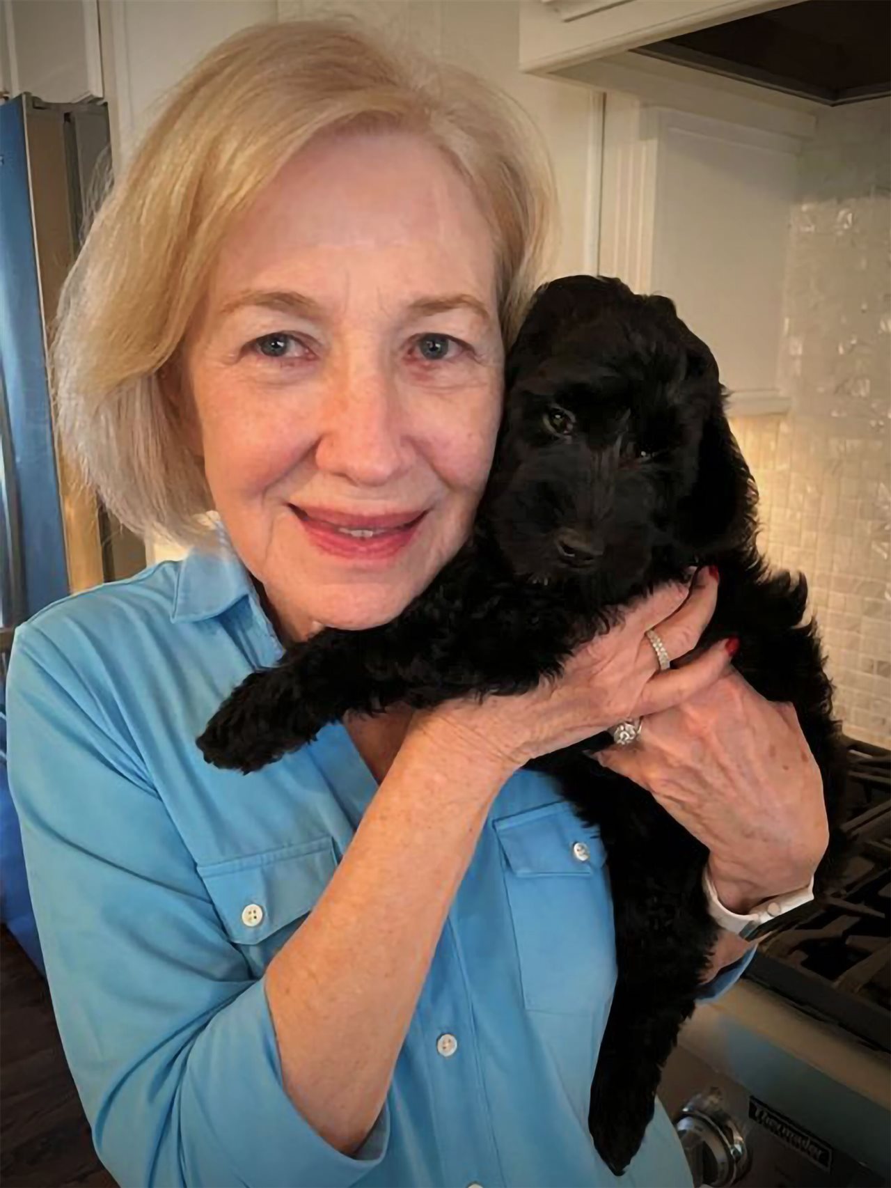 Lavonda cuddling her dog.