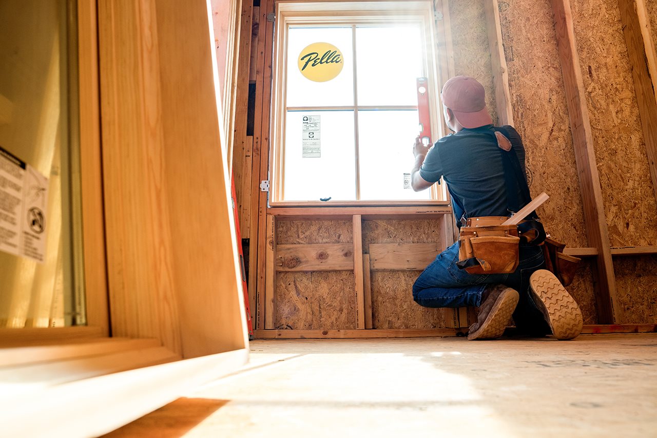 Man installing a Pella window.