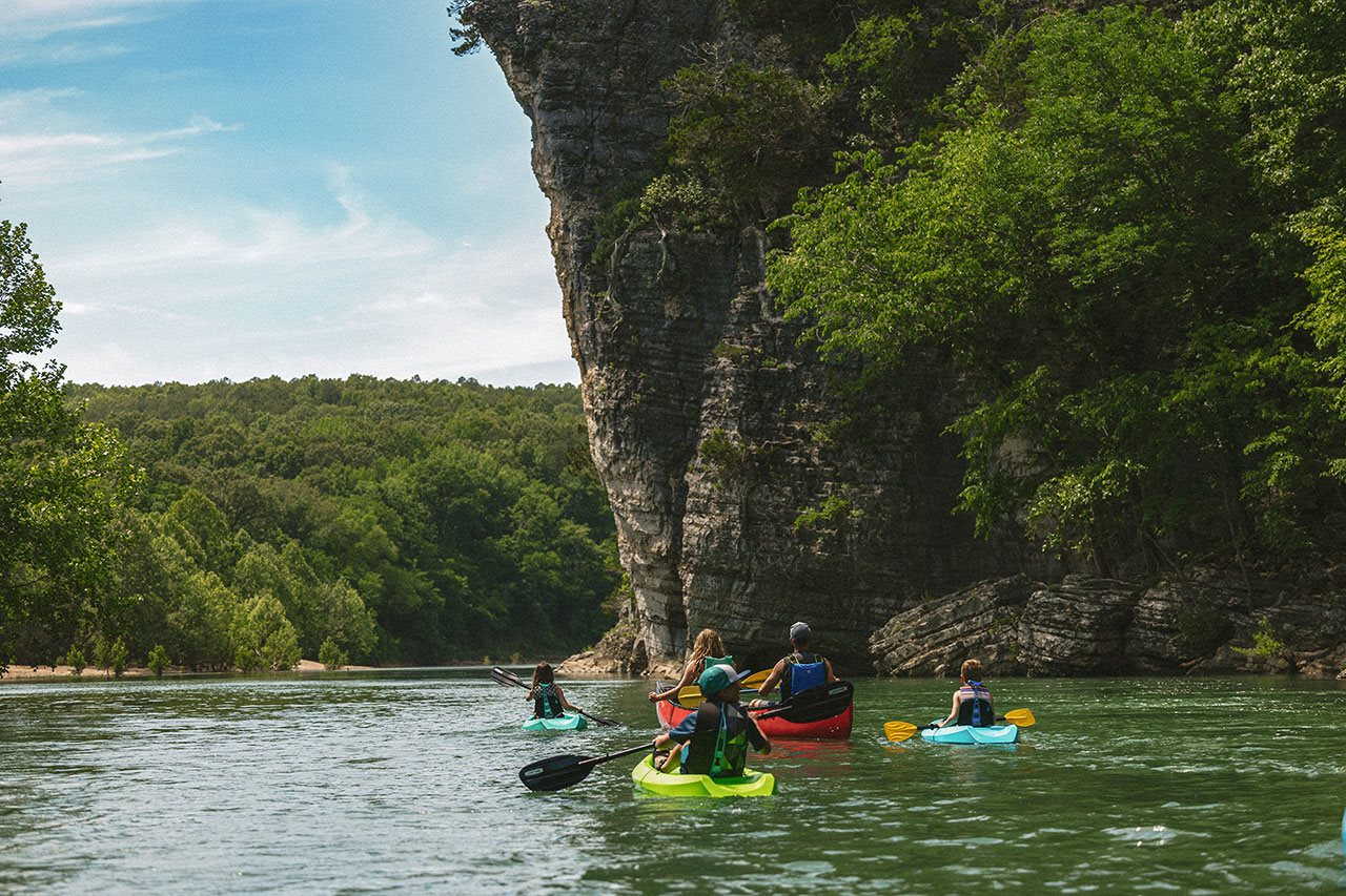 People paddling in boats on the water in Buffalo Parks