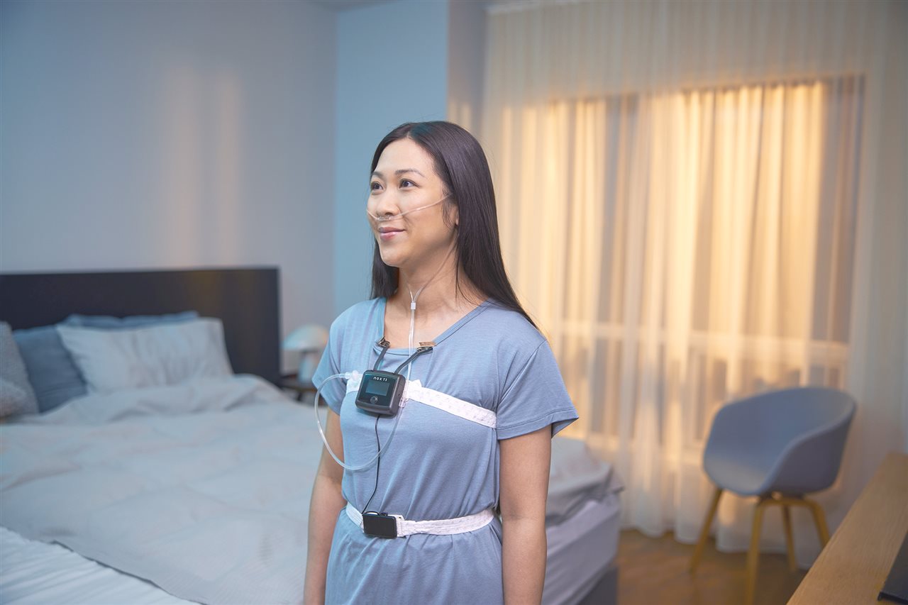 Woman wearing sleep monitor. Nox Medical helps modernize the practice of sleep medicine.