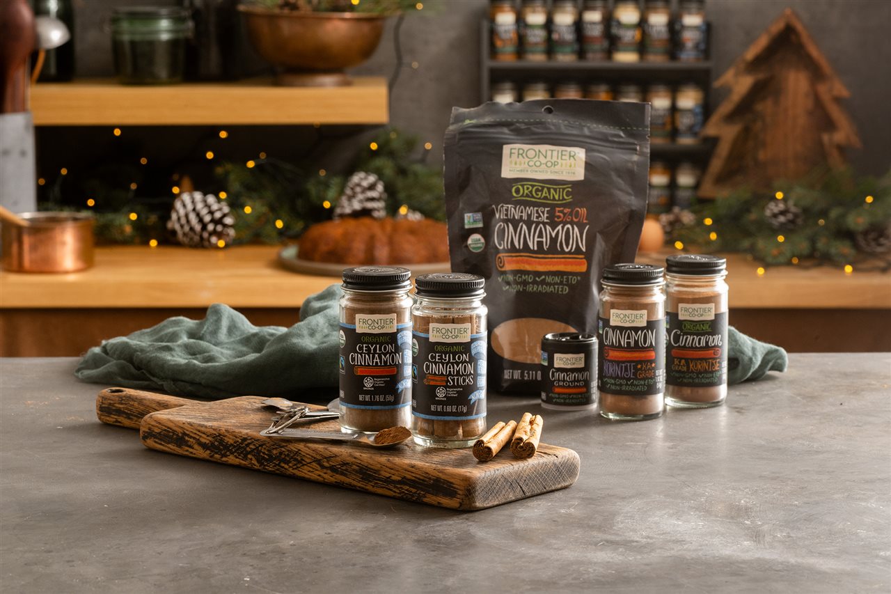 Beautiful rustic kitchen decorated for the holidays and a variety of Frontier Co-op spices on the island counter top.