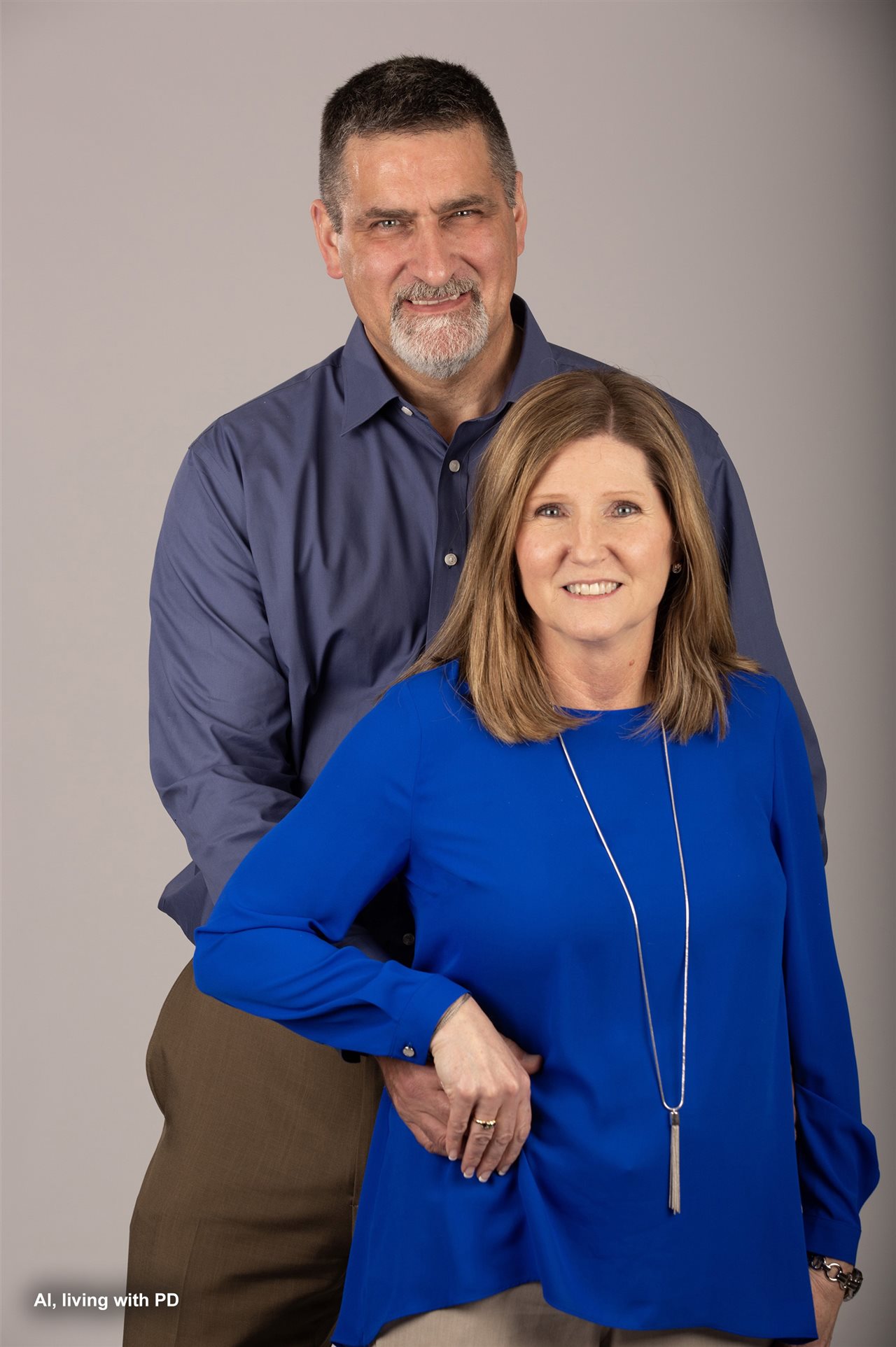 Al and Lisa against a grey background