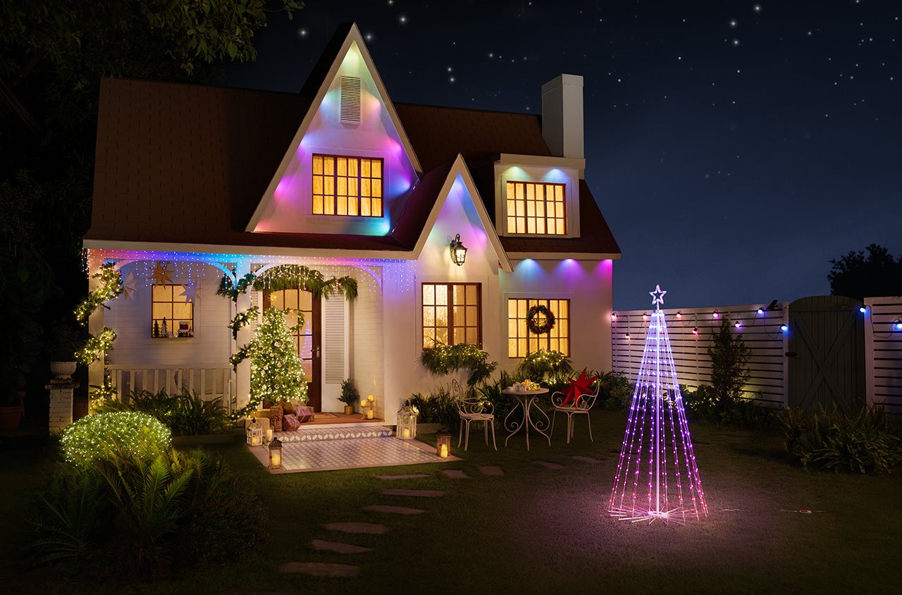 Outdoor light display on a home and outdoor tree made of lights.