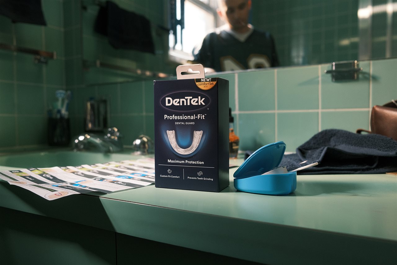 Den Tek mouth guard box and instructions for use on the counter near the bathroom sink.