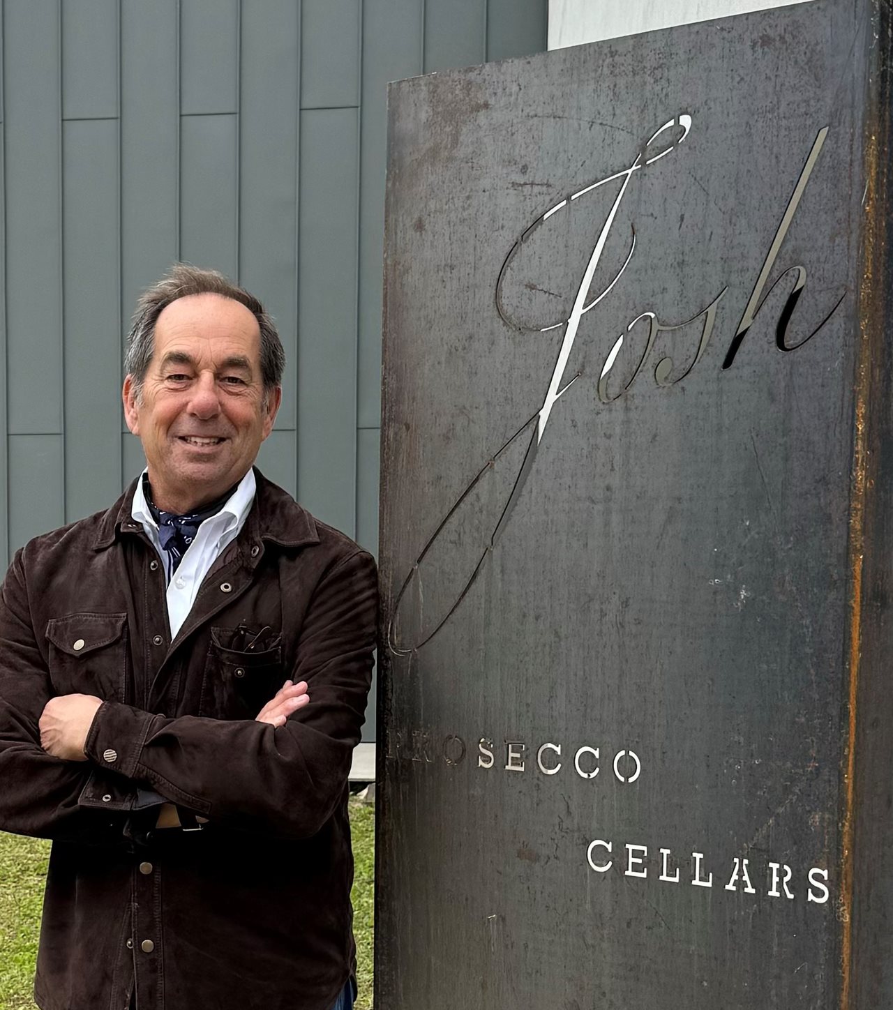Joe Carr standing in front of a sign that says 