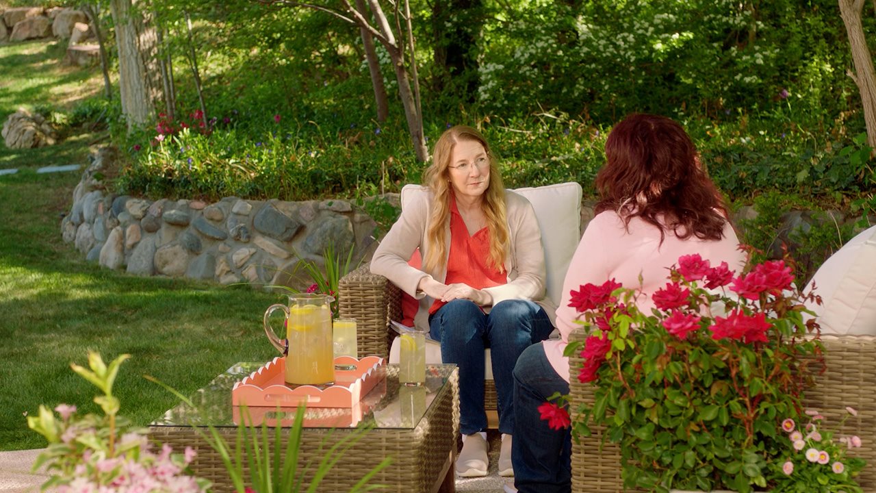 Moira being interviewed while sitting in a garden