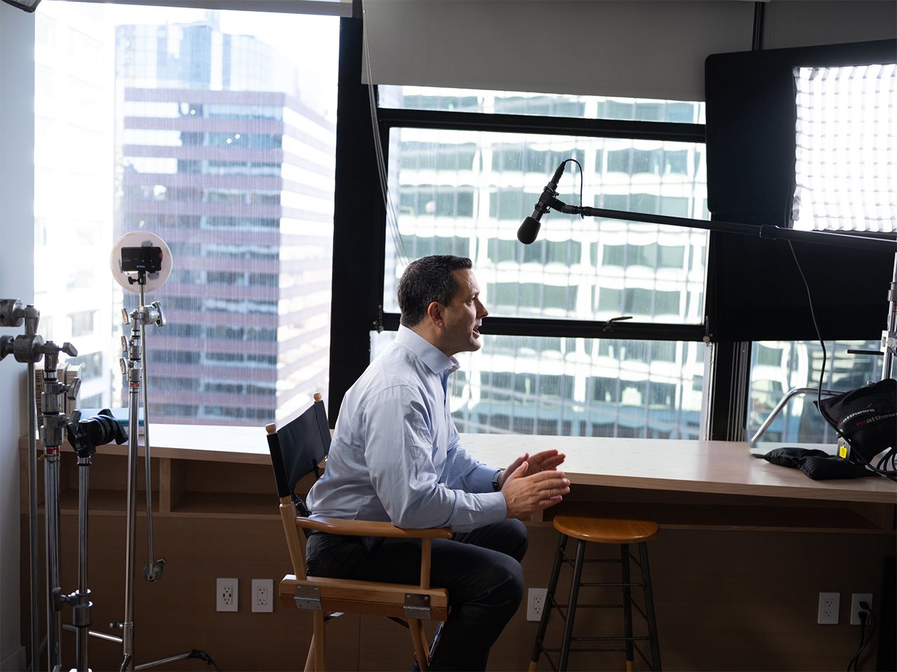 Adam talking on a media outlet from an office setting