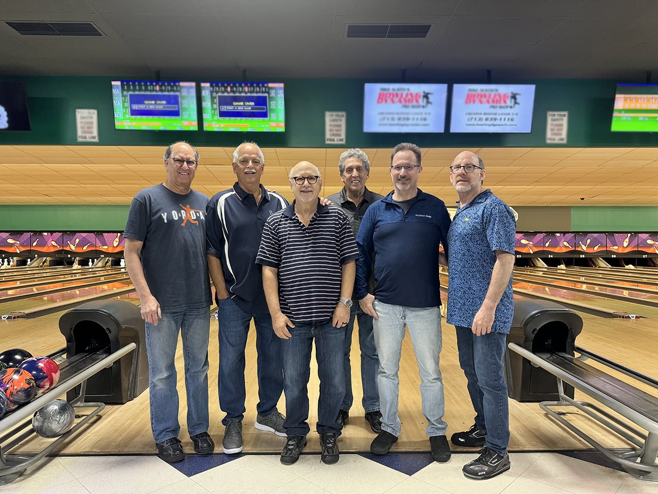 Jeff with five of his friends at a bowling alley. Jeff is living with Parkinson's disease.